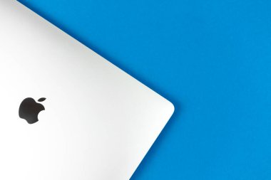 Apple Macbook parlak mavi masa arka planında. İş ve ofis konsepti, üst görünüm, düz yatak