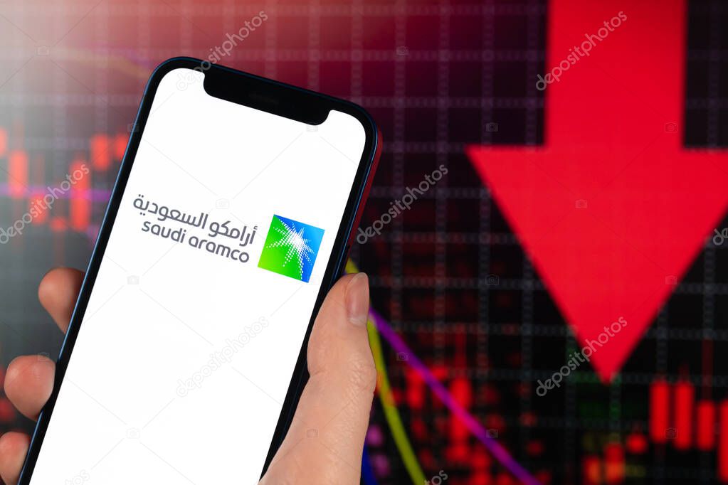 Kharkov, Ukraine - February 11, 2022: Saudi Aramco stock trade on red chart. Arabian oil company, gas industry. Finance market background