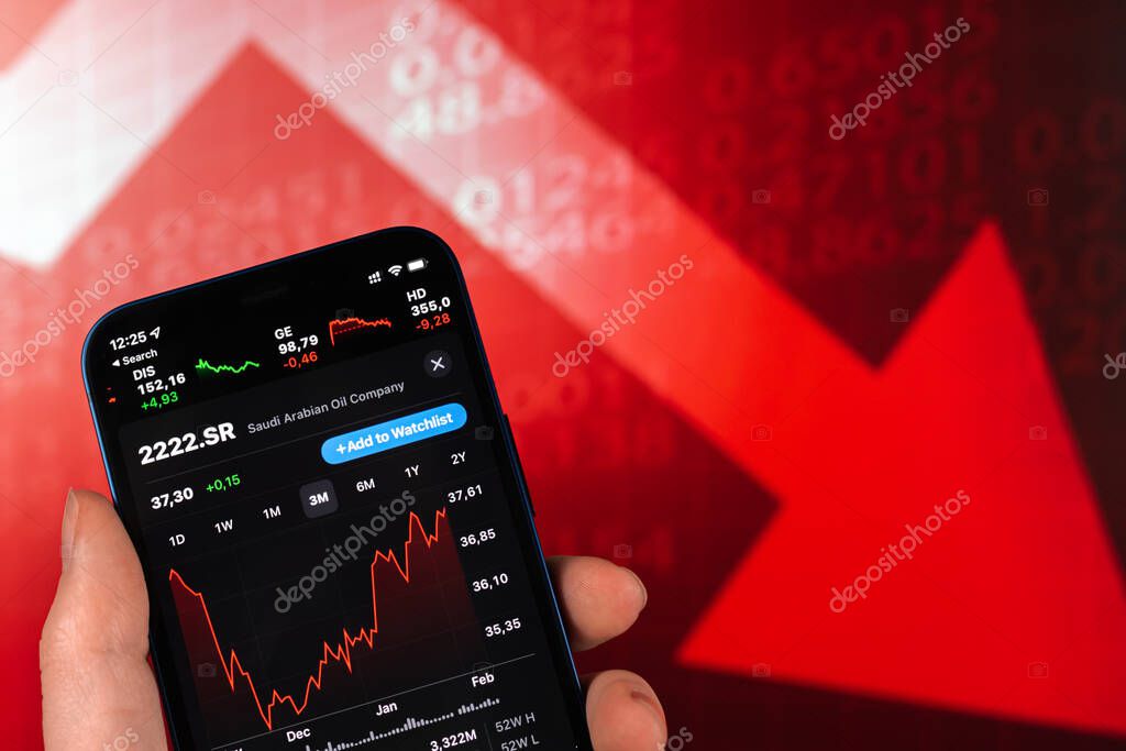 Kharkov, Ukraine - February 11, 2022: Saudi Aramco stock trade on red chart. Arabian oil company, gas industry. Finance market background