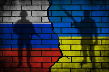 Rusya, Ukrayna çatışmasına ve savaş bayraklarına karşı. Silahlı askerlerin silueti tuğla duvarda.