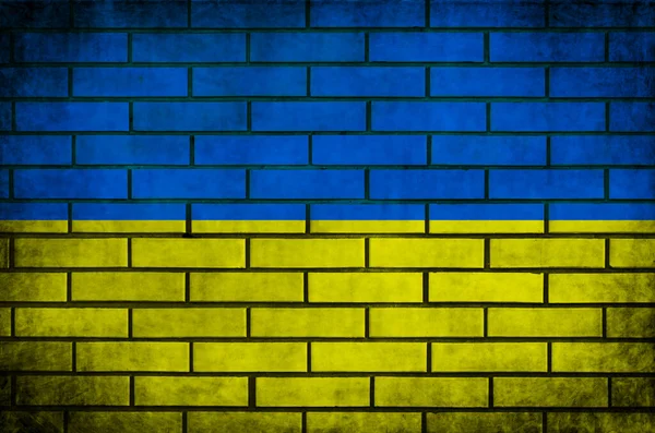 Textura de la bandera ucraniana en pared de ladrillo. Grunge foto de fondo —  Fotos de Stock