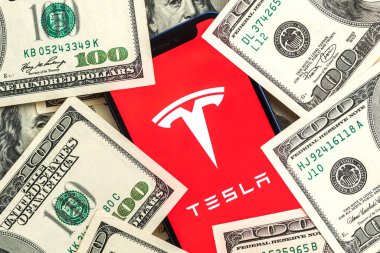 Poltava, Ukrayna - 26 Nisan 2022: Tesla araba şirketi borsa geçmişi. Tesla logosu Twitter 'da ve dolar para yakın plan görüntüsü 