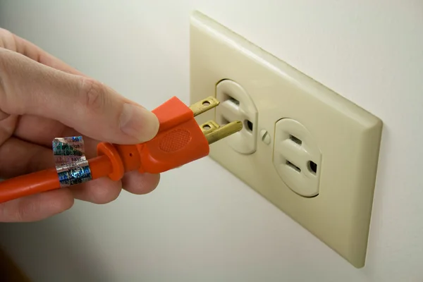 Plugging Electrical Cord into Wall Outlet — Stock Photo, Image