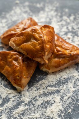 Bakery pastries on white and grey background. Freshly cooked bakery. Home cooked bakery for morning breakfast. Copy space. Vertical shot. Selective focus