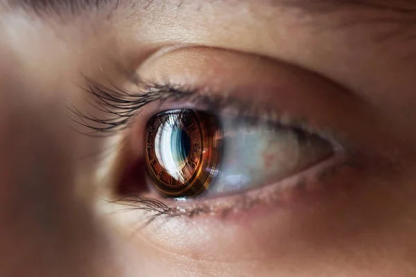 stock image Manipulation of the eyeball with a macro photographed and a clock image