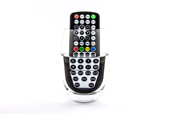 Waterproof TV remote control in a glass of water — Stock Photo, Image