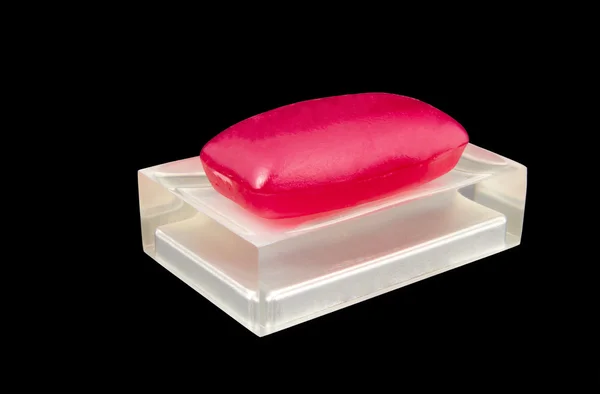 Classic red soap on a semi transparent soap dish — Stock Photo, Image