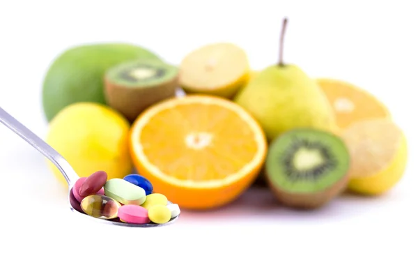 Spoon full of colorful pills — Stock Photo, Image