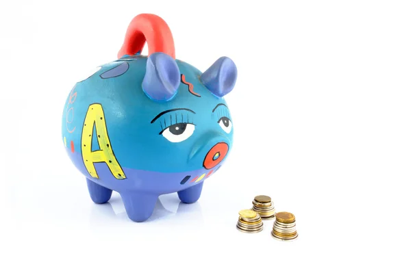 Money saving in a colorful piggy bank — Stock Photo, Image