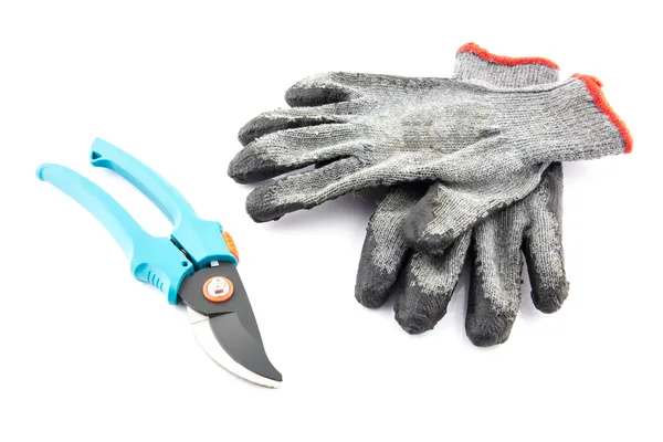 Pruning shears and gardening worn gloves — Stock Photo, Image