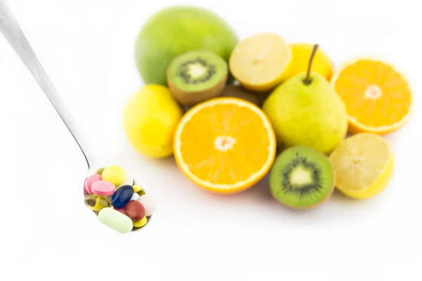 Spoon full of colorful pills — Stock Photo, Image