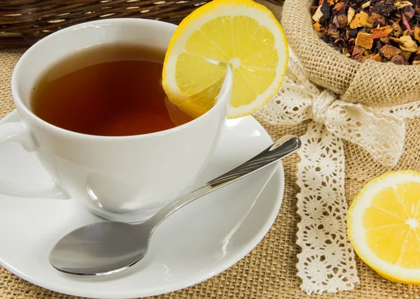 Taza caliente de té y hojas secas de hierbas — Foto de Stock