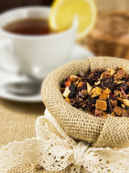 Taza caliente de té y hojas secas de hierbas — Foto de Stock