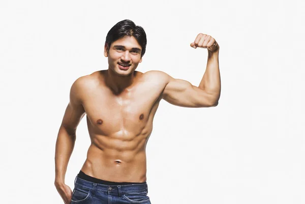 Portrait of a man showing his biceps — Stock Photo, Image