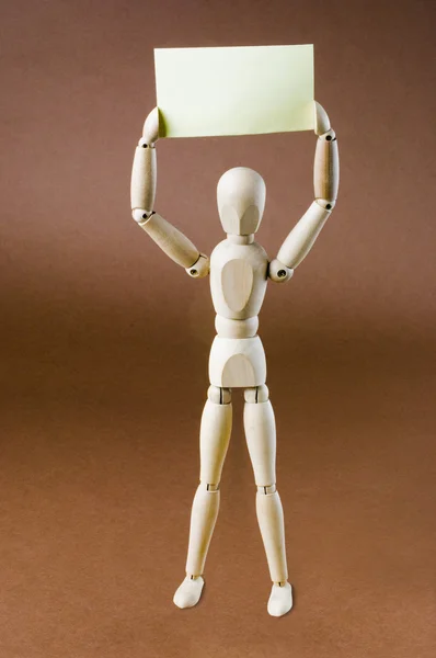 Figurina segurando um cartaz em branco — Fotografia de Stock