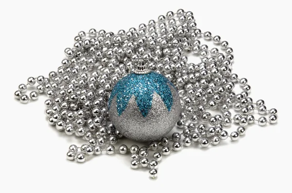 Silver and blue bauble on string of silver beads — Stock Photo, Image