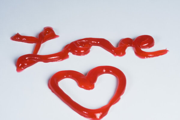 Word Love and heart shaped made from jam