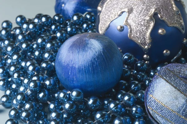 Blue Christmas balls with a string of blue beads — Stock Photo, Image