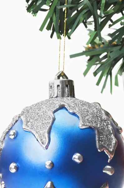 Blue bauble hanging on a Christmas tree Stock Picture