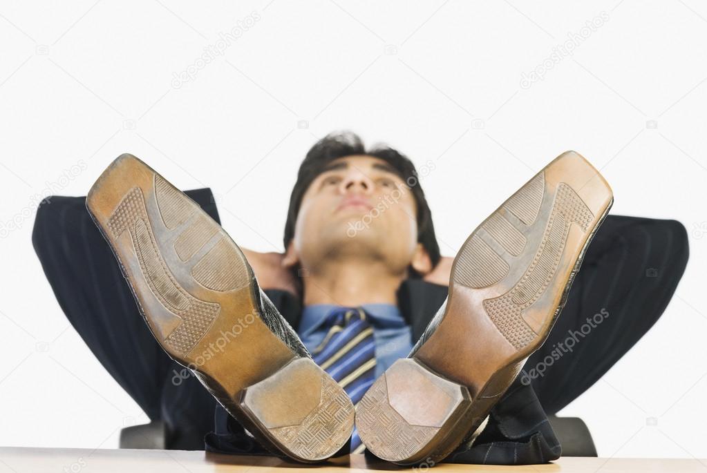 Businessman with feet up on a desk