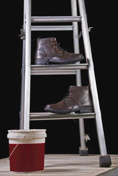 Leren laarzen op een ladder stap — Stockfoto