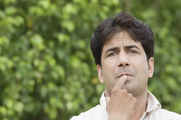 Man thinking in a park — Stock Photo, Image