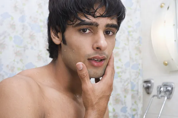 Man touching his face after shave — Stock Photo, Image