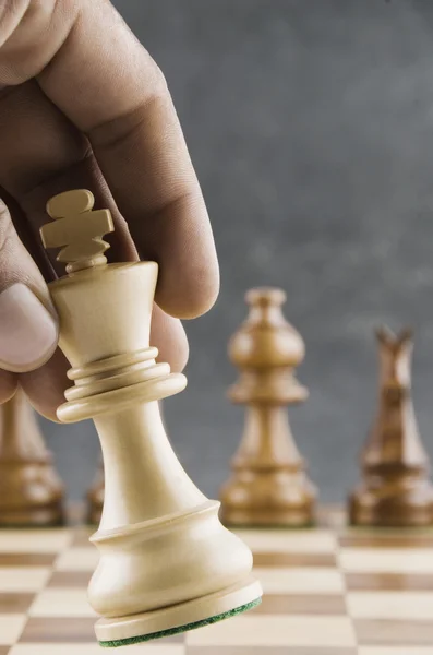 Human hand moving a king chess piece — Stock Photo, Image