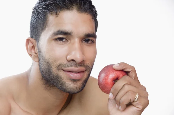 Macho man eating apple — Stock Photo, Image