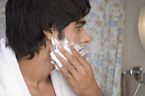 Man applying shaving cream on his face — Stock Photo, Image