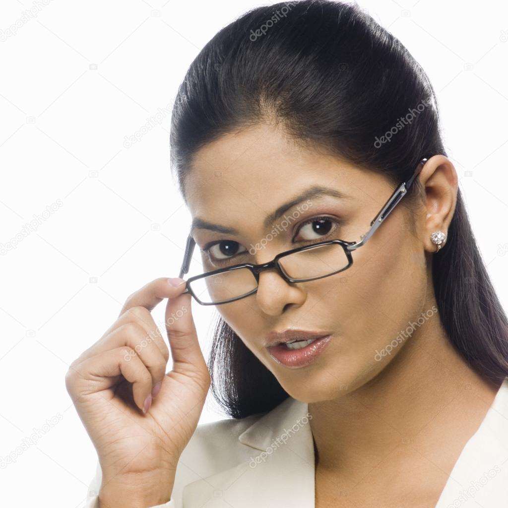Businesswoman holding her eyeglasses