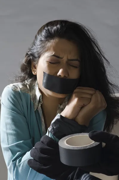 Hands wrapping adhesive tape around woman's hands — Stock Photo, Image