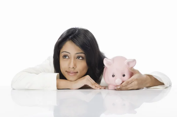 Businesswoman with a piggy bank — Stock Photo, Image