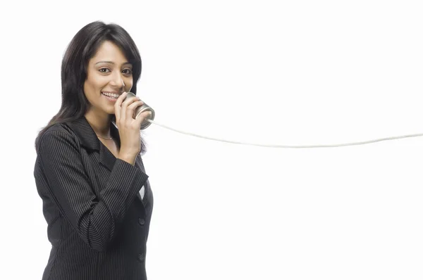 Businesswoman speaking in a tin can phone — Stock Photo, Image