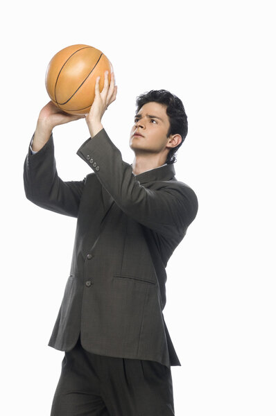 Businessman playing basket ball