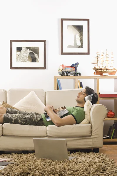 Man lying on a couch — Stock Photo, Image