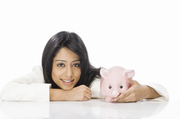 Businesswoman with a piggy bank — Stock Photo, Image