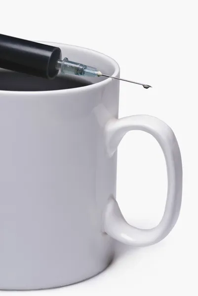 Coffee cup with a syringe — Stock Photo, Image