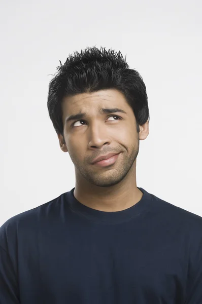 Man making a funny face and looking up — Stock Photo, Image