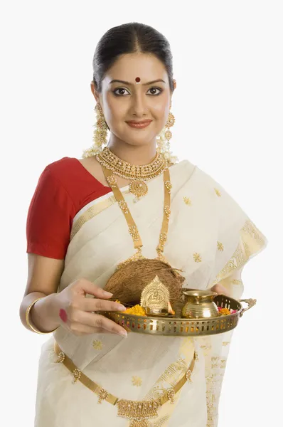 Woman holding a plate of religious offerings — Stock Photo, Image