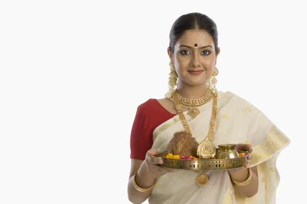 Woman holding a plate of religious offerings — Stock Photo, Image