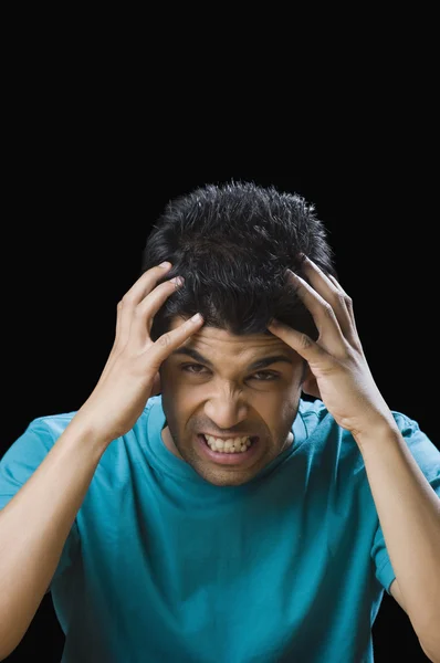 Frustrated man holding his head — Stock Photo, Image