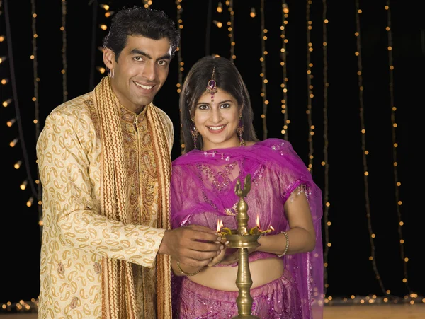 Couple lighting oil lamp on Diwali festival — Stock Photo, Image