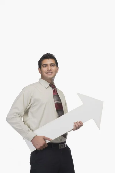 Podnikatel drží znaménko šipka — Stock fotografie