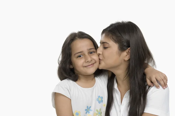 Woman kissing her daughter — Stock Photo, Image
