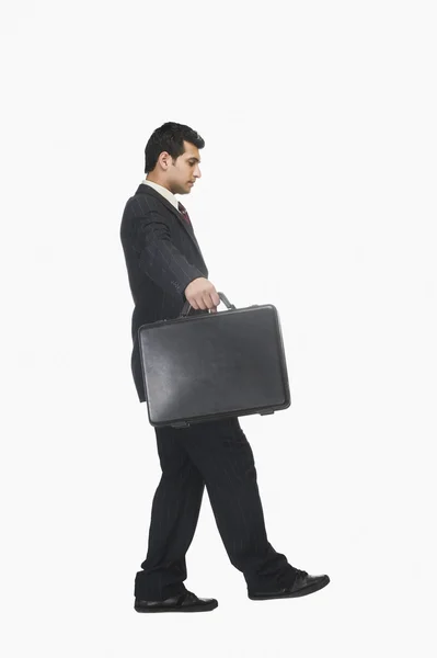 Businessman walking carefully with a briefcase — Stock Photo, Image