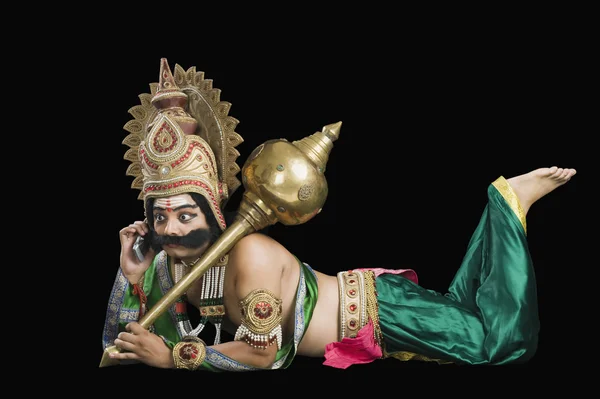 Man dressed-up as Ravana talking on a mobile phone — Stock Photo, Image