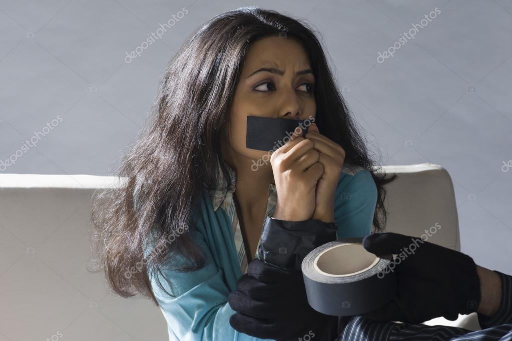 Hands wrapping adhesive tape around woman's hands — Stock Photo