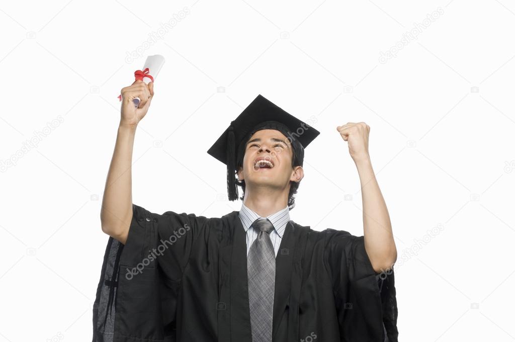 Graduate holding his diploma