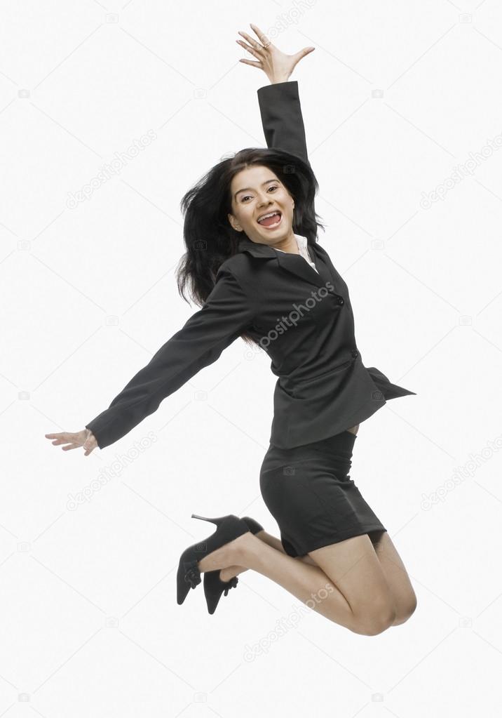 Businesswoman jumping with joy